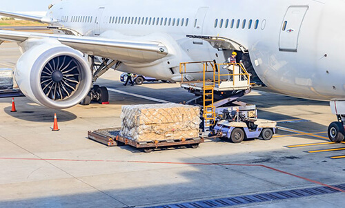 forklift loading cargo into the cargo compartment of the plane